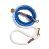 A vibrant cobalt blue cotton rope dog leash with solid brass bolt snaps, hand-spliced ends, and an individually numbered tag, designed for durability and style.

