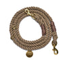 A beautifully handcrafted dark tan rope dog leash featuring solid brass bolt snaps, hand-spliced ends, and an adjustable design for secure and stylish walks.